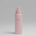 A matte pink water bottle with a matching pink lid and carrying loop, featuring the brand name 'NATURE SITAYURI' printed vertically in gold. The bottle is placed horizontally on a textured green artificial grass surface.