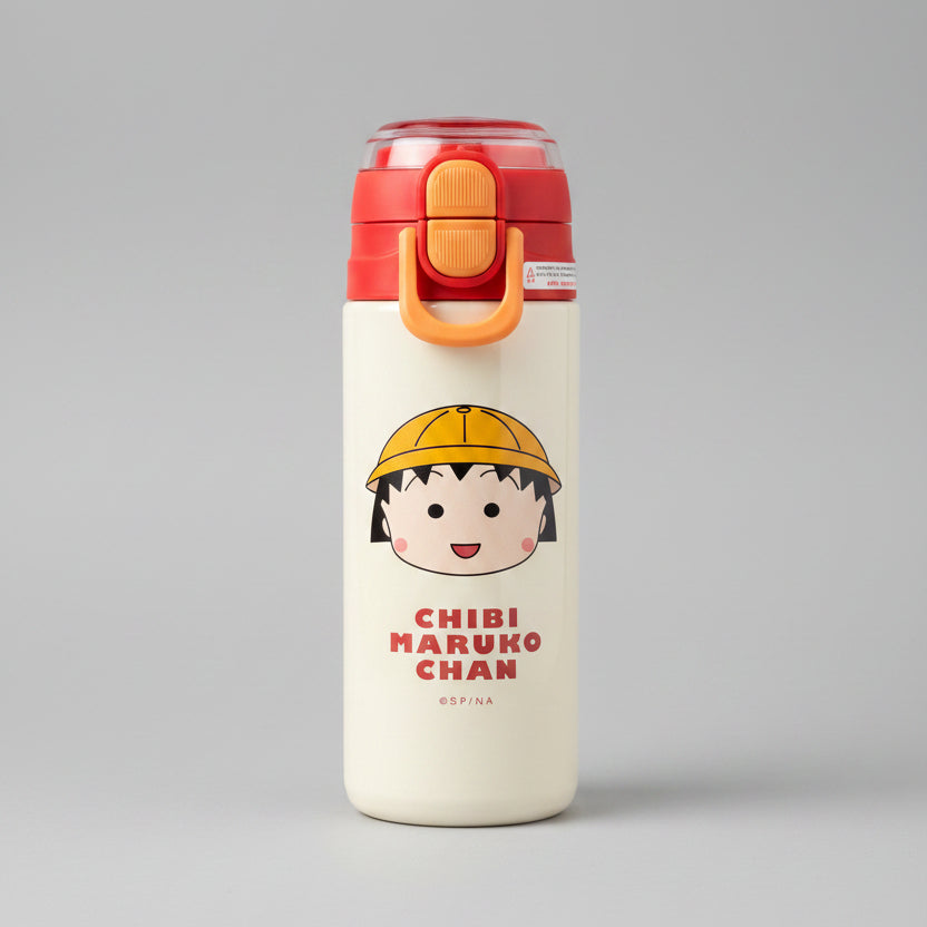 A Chibi Maruko water bottle with a cream-colored body, red and orange lid, and a printed cartoon character on a green grass background.
